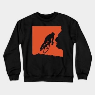 Bikerider rides the bicycle, black silhuette on orange background Crewneck Sweatshirt